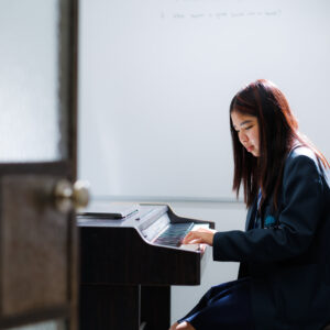 A student playing the piano